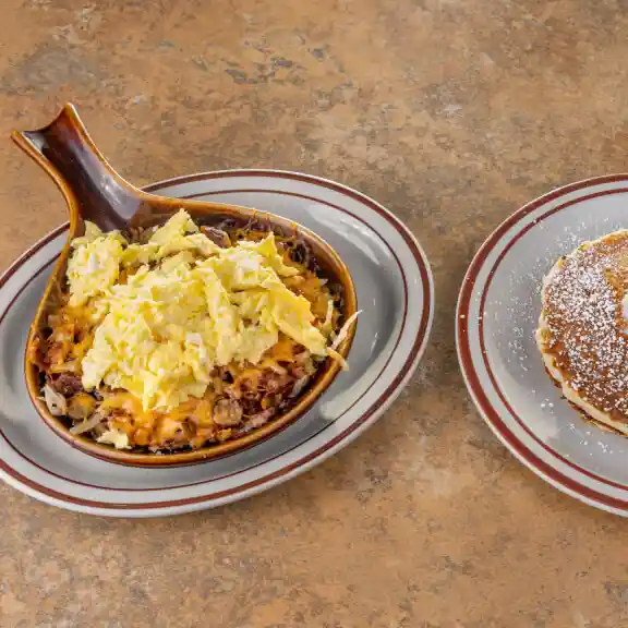 Skillet scramble served in a cast iron pan with a side pancake