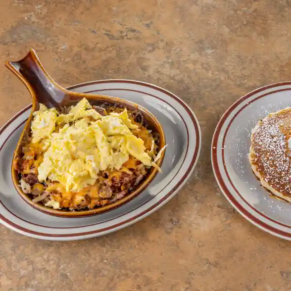 Cast iron skillet scramble with a side of buttered pancake