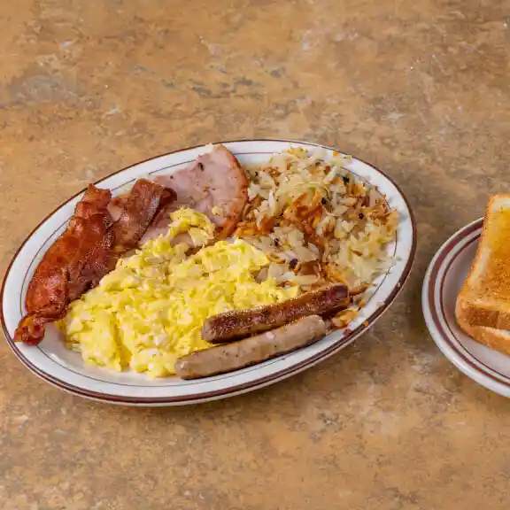 Breakfast plate with scrambled eggs, bacon, sausage, hash browns, and toast