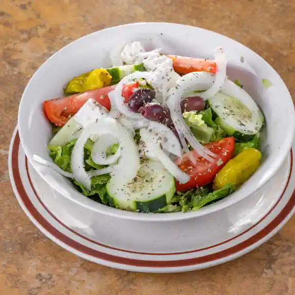 Greek salad with olives, cucumber, onion, and tomato