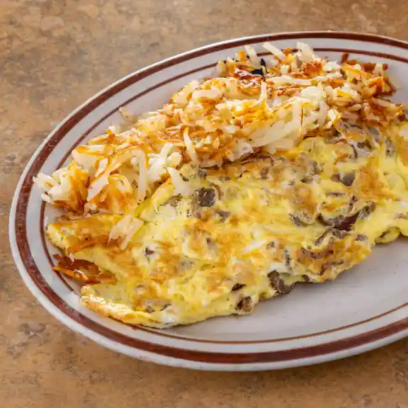 Mushroom and cheese omelette served with hash browns